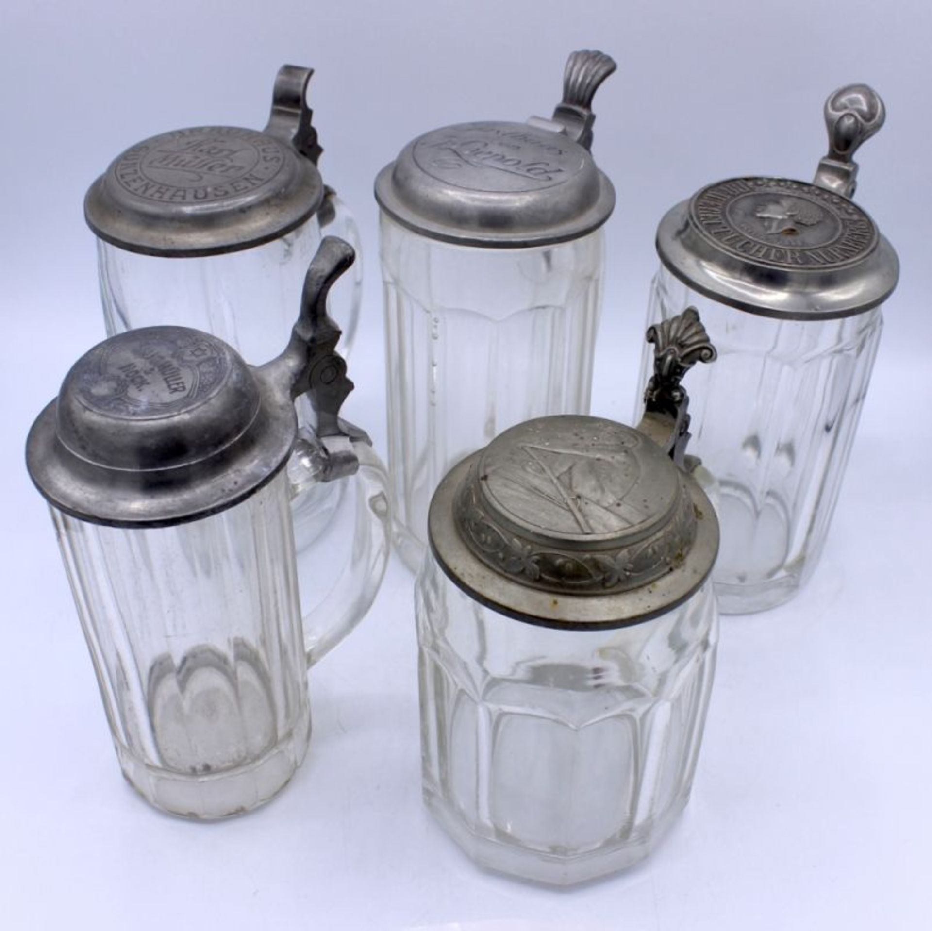 Lot von 5 Bierkrügen 0,5 L., 6/2 L, 1/2 L., Zinndeckel, Glas, Altersspuren, Höhe ca. 16,5-19 cm,