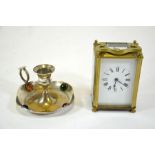 A French gilt brass carriage timepiece and chamberstick