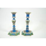A pair of French faience candlesticks