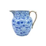 A large Staffordshire pearlware blue and white transfer printed jug, lotus flower design