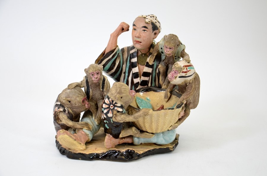 A Japanese pottery figure group