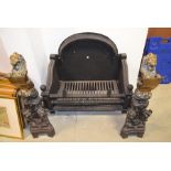 A pair of 19th century cast iron and brass firedogs, with grate