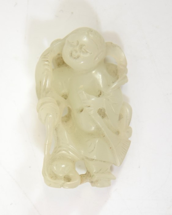 A Chinese jade carving of a boy with broom