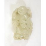A Chinese jade carving of a boy with broom