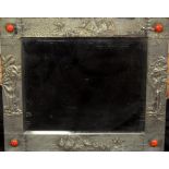 An Arts and Crafts pewter and cabochon set mirror