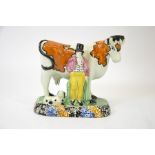 A Staffordshire prattware figure of a cow, man and dog