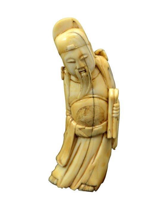 A Chinese carved walrus ivory figure of an immortal