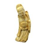 A Chinese carved walrus ivory figure of an immortal