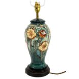 A Moorcroft lamp base decorated with flowering vine,