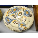 A pair of 18th century Delft plates, painted with polychrome flowers