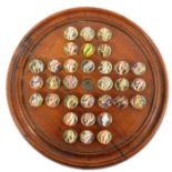 A mahogany solitaire board and 32 brightly coloured candystripe swirl marbles, board 21.5 cm, marbl