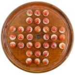 A wooden solitaire board with 32 glass red/white patch type marbles 16 mm, board 19.5 mm.