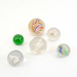 Six large Victorian marbles to include a green glass mica, solid core swirls and cat, dog and lion s