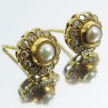A pair of gold, pearl and diamond stud earrings