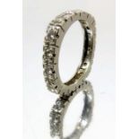 A white metal and diamond eternity ring