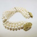 A three strand pearl and 9 carat gold bracelet