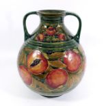 William Moorcroft for James MacIntyre, a large Pomegranate on ochre twin handled vase