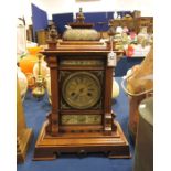 A clock in a wooden case, round brass dial with Ro