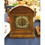 A clock in a walnut case, round brass dial with Ro