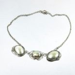 An Arts and Crafts silver and mother of pearl wirework necklace