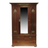 An Arts and Crafts mahogany three bay wardrobe