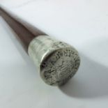 A white metal mounted cane / walking stick