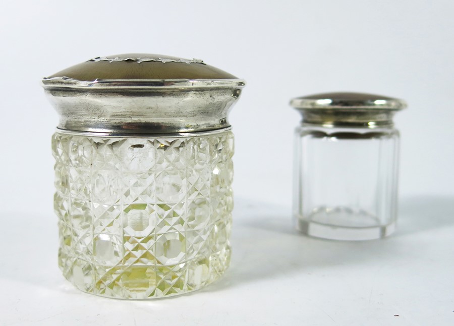Two George V silver and tortoiseshell cut glass bottles or jars