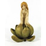 A Royal Dux figure of a girl in a water lily