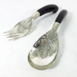 A pair of Persian white metal and ebony handled salad servers