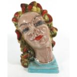 An Art Deco figure of a womans head, Czechoslovakian, polychrome decorated glazed earthenware,