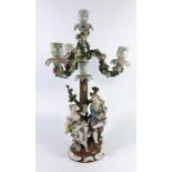 A Continental porcelain figural three branch candelabrum