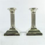 A pair of Edwardian silver dwarf candlesticks