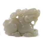 A Chinese jade carving of a boy on the back of a dragon
