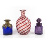 Three glass scent bottles including a French Palais Royale blue and brass overlay bottle