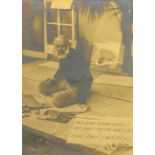 A signed portrait photograph of William Lionel Wyllie, painting outside a house