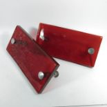 A pair of red push and pull glass door handles