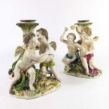A pair of Meissen style figural candlesticks
