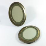A pair of George V silver oval photo frames