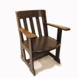 E G Punnett for Liberty and Co., an Arts and Crafts oak armchair