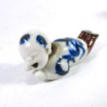 An Oriental novelty articulated porcelain figure of a boy