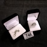 Two white metal rings, both cased