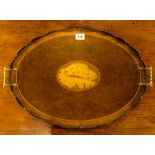 An oval two handled tray with central shell motif