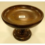 An oak pedetal fruit bowl