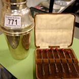 A cocktail shaker and cased set of sticks