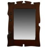 An Arts and Crafts walnut and patinated copper mirror