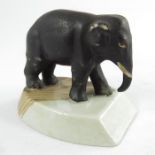 A Staffordshire elephant, circa 1860, modelled standing on a plinth, 5cm high