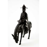 An Oriental bronze figure of a man on a horse