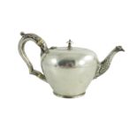 A mid 18th century Scottish provencial silver teaport, circular shape, floral decoration to the spou