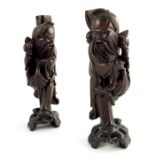 Three wood carved Chinese figures, depicting a pair of sages and a parent and child riding a buffalo