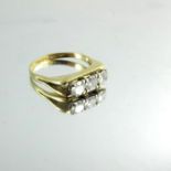 An 18 carat gold and three stone diamond ring